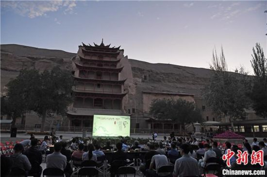 2018年8月，在敦煌莫高窟標(biāo)志性建筑“九層樓”前，《回顧平山郁夫先生的貢獻(xiàn)》座談會舉行。來自中日兩國的專家、學(xué)者共同懷念這位情系敦煌數(shù)十載的繪畫巨匠、中日友好的文化使者、世界文化遺產(chǎn)的守護(hù)者。中新社記者 楊艷敏 攝